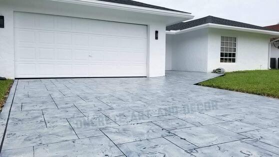 Picture of a finished driveway in a modern concrete overlay design.