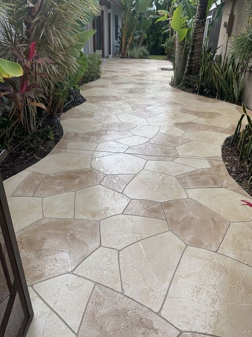 stamped concrete walkway along lush landscaping