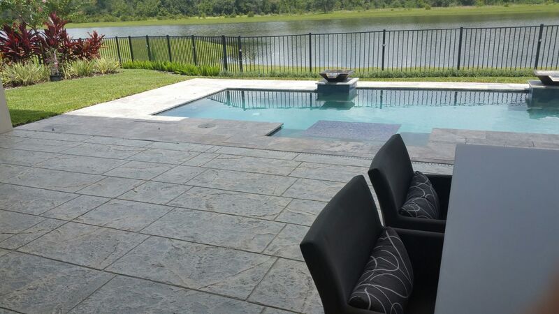 stamped concrete patio in modern home overlooking pool and conservation area