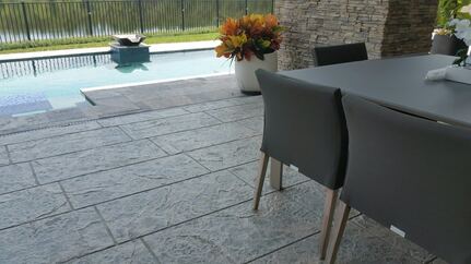 Picture from patio table overlooking stamped concrete pool deck