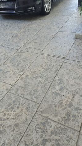 pool deck resurfaced with stained stamped concrete